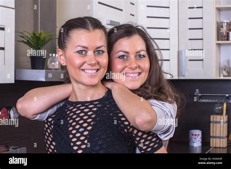 Happy Twins Close Up Portrait In The Kitchen On Background Stock Photo