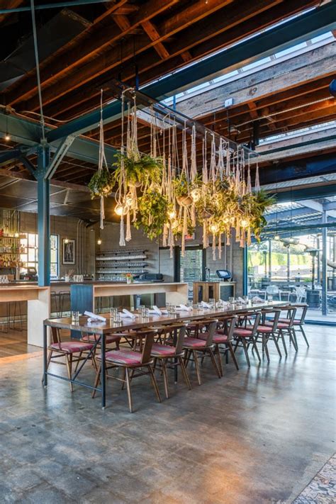 An Indoor Dining Area With Chandeliers Hanging From The Ceiling