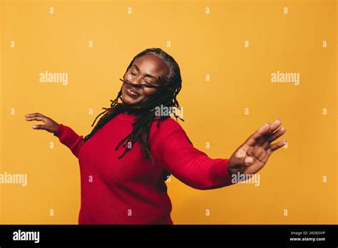 Joyful Mature Woman Dancing And Having Fun While Standing Against A