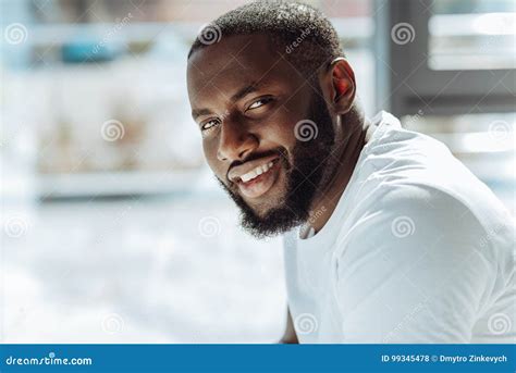 Joyful Handsome Afro American Man Smiling In Front Of The Camera Stock