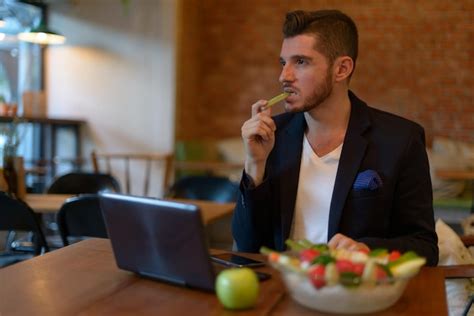 Premium Photo Man Using Mobile Phone While Sitting On Table