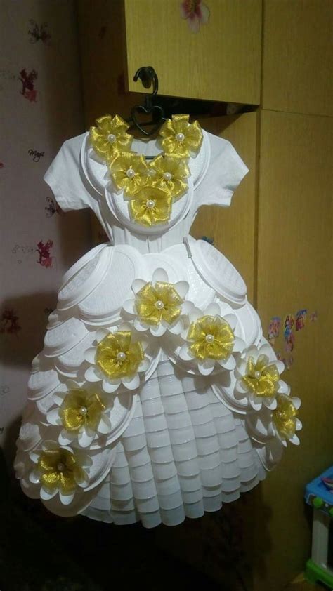 A Dress Made Out Of Paper With Yellow Flowers On It