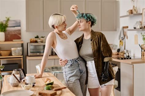 Premium Photo Lovely Lesbian Couple Spending Time For Cooking In The Kitchen