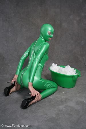 Busty Babe In Green Latex Jumpsuit Posing With A Bowl XXX Dessert