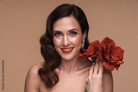 Beauty Portrait Of Brunette Adult Half Naked Woman Holding Red Flowers Stock Photo Adobe Stock
