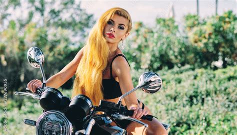 Beautiful European Woman With Blond Long Hair Wearing Black Lingerie Sitting On Motorcycle