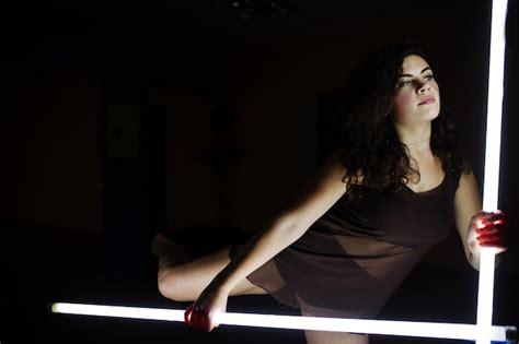 Premium Photo Curly Brunette Plus Size Model With Two Long Led Lamp
