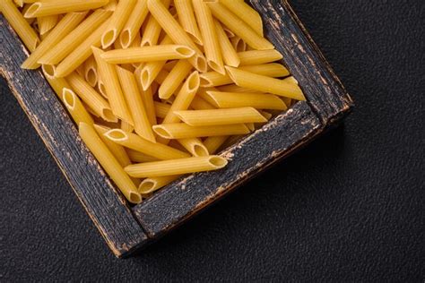 Premium Photo Raw Penne Pasta From Whole Grain Wheat Varieties With