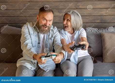 Mature Couple Playing Video Games And Looking Excited Stock Photo Image Of Couple Game