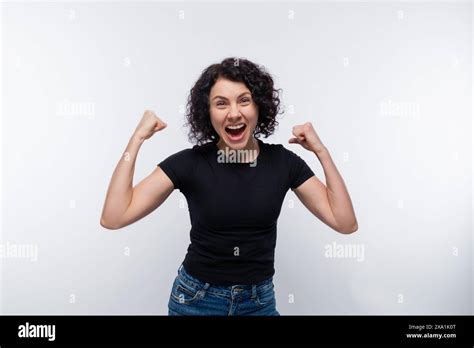 Happy Joyful Curly Brunette Woman Clenched Her Fists Stock Photo Alamy