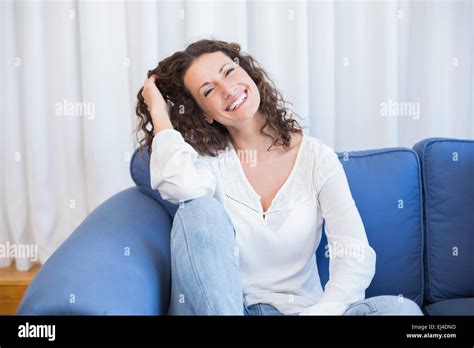 Pretty Brunette Relaxing On The Couch Stock Photo Alamy