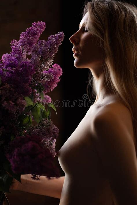 Topless Profile Of A Blonde Woman With A Bare Breast And A Bouquet Of
