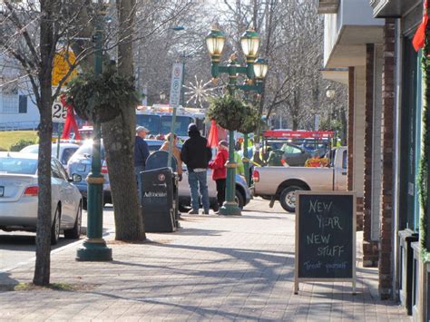 Woman Drives Off Road Onto Downtown Sidewalk And Takes Out Light Pole