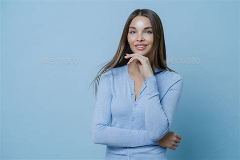 Satisfied Brunette Lady Touches Jawline Gently Has Applied Makeup