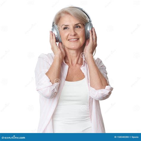 Beautiful 50 Years Old Woman Is Listening To Music In Headphones Stock