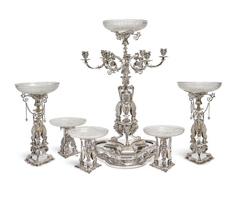 A VICTORIAN SILVER PLATED AND CUT GLASS SEVEN PIECE TABLE GARNITURE