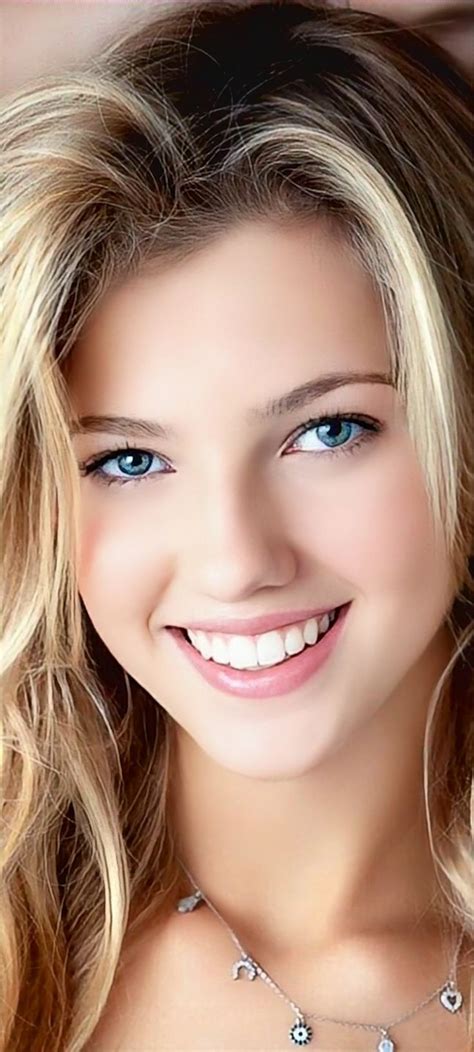 A Beautiful Blond Woman With Blue Eyes And Blonde Hair Smiling At The Camera While Wearing A