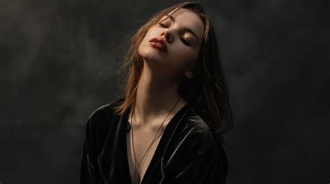 Bold and unapologetic a woman stands with her head tilted back wearing ...