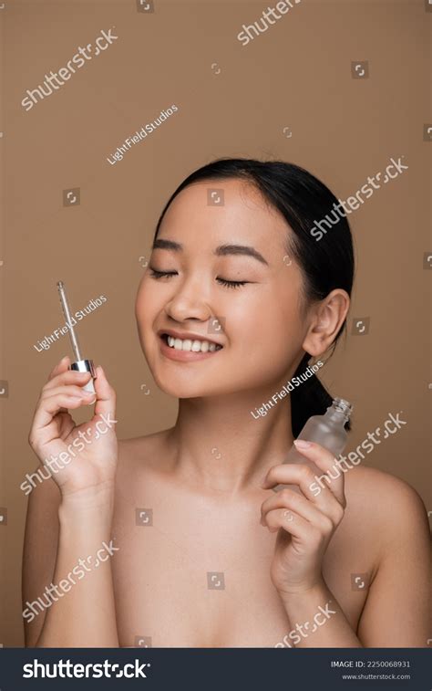 Positive Asian Woman Naked Shoulders Holding Stock Photo