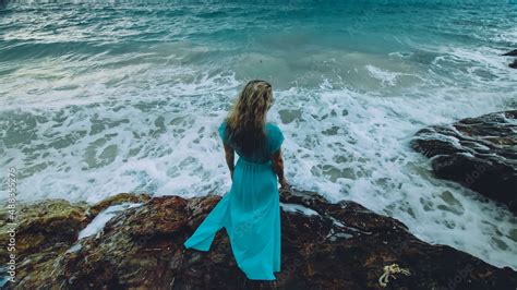 Sexy Hot Woman Meditates Relaxes On A Rock Reef Hill In Stormy Morning Rain Cloudy Sea Girl In