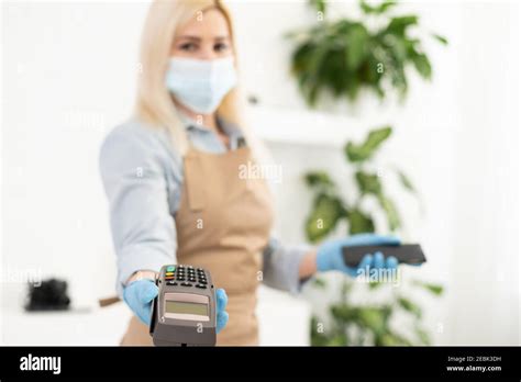 Masked Blonde Girl With Pos Terminal Stock Photo Alamy