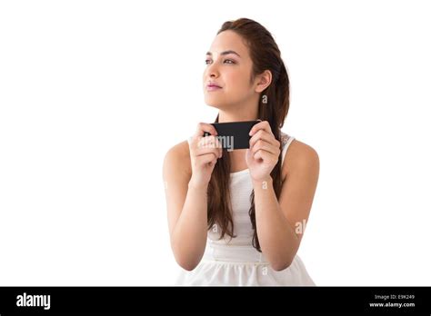 Thoughtful Brunette Holding Her Phone Stock Photo Alamy