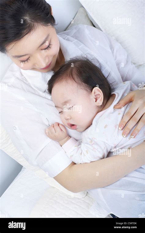 A Mother With Her Baby Sleeping Stock Photo Alamy