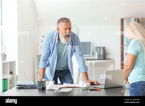 Angry Mature Boss Scolding Her Secretary In Office Stock Photo Alamy