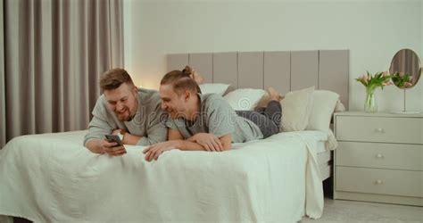 Cute Male Gay Couple Spend Time Lying Down Sofa Bed Use Smartphone Stock Footage Video Of