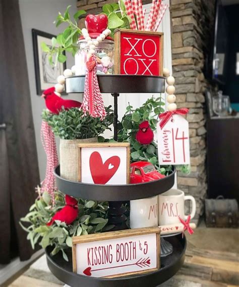 A Three Tiered Tray With Valentine S Day Signs On It