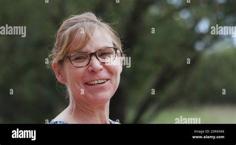 K Close Up Portrait Of Mature Woman With Glasses Looking Into The Camera And Stock Video