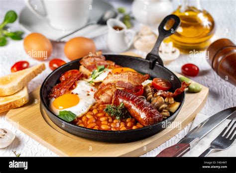 Traditional English Breakfast With Fried Eggs Sausages Beans