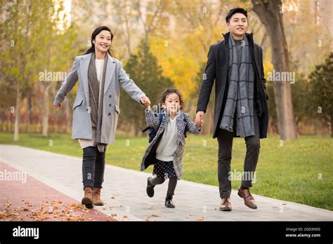 Parents Picking Up Child From School Stock Photo Alamy