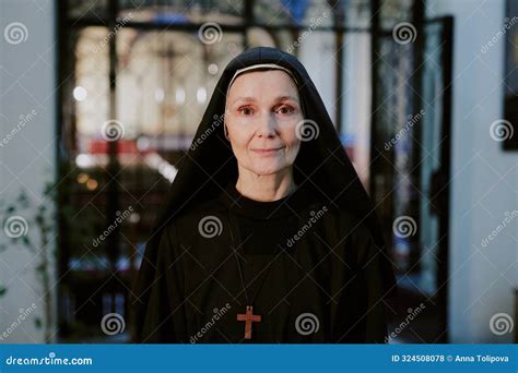 Mature Nun In Black Habit Looking At Camera Stock Photo Image Of Pious Sister 324508078