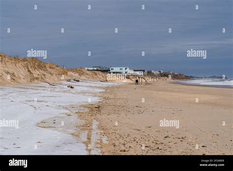 The Beach In Montauk During The Winter With Snow Covering Part Of The
