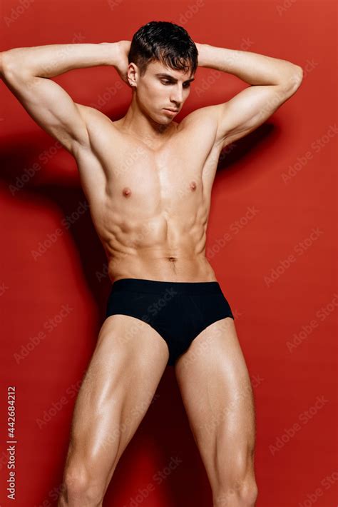 Nude Man In Underpants Bodybuilder Fitness Pose On Red Background Model Stock Photo Adobe Stock