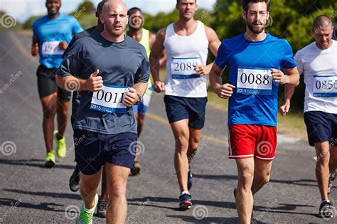 road  long  group  young men running  marathon stock image