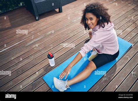 Brunette Woman With Curly Hair Enjoying Sport Stock Photo Alamy