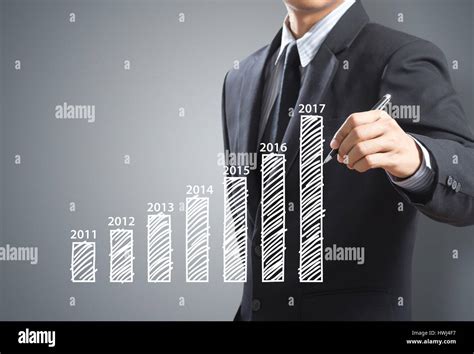 businessman writing graph year  year stock photo alamy
