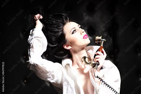 Sexy Brunette Woman And Gold Telephone Stock Photo Adobe Stock