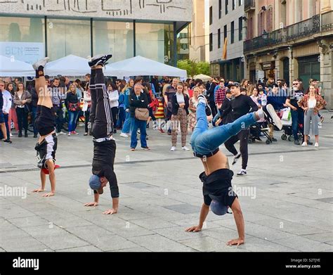 Three Street performers doing handstands during a dance performance in ...