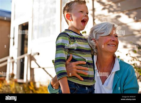 Mature Woman Hugging Her Excited Grandson Stock Photo Alamy