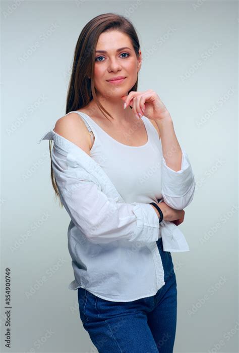 Smiling Positive Emotional Woman Wearing White Shirt Standing With Naked Shoulders Stock Photo