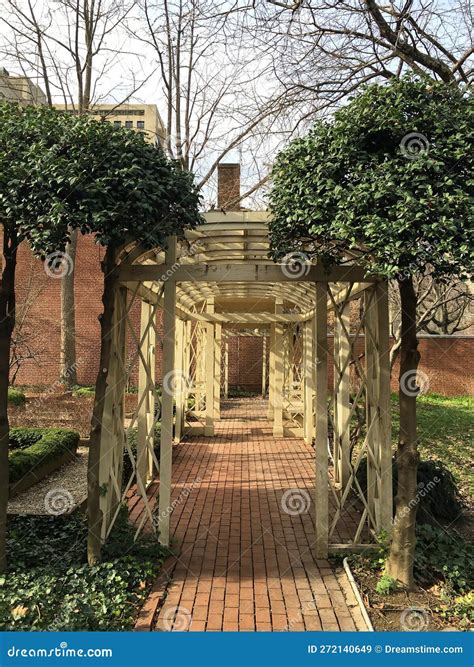 Wood Archway and Brick Path in a Garden Editorial Stock Image - Image