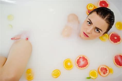 Premium Photo Sexy Brunette Girl At The Bathroom With Milk And Fruits Youth Bath For Body
