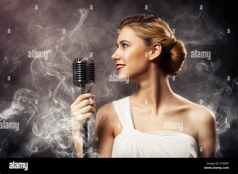 Beautiful Blonde Woman Singer With A Microphone Stock Photo Alamy