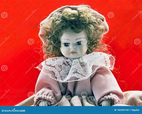 Beautiful Porcelain Brunette Doll Portrait With Vintage Dress And Curly Hairs And And Thoughtful