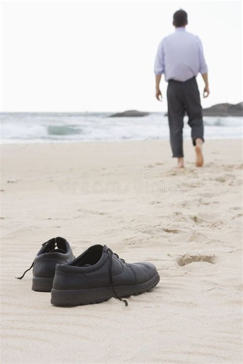 Businessman walking barefoot on beach royalty free stock images ...