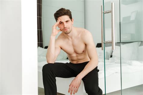 Premium Photo Serious Naked Man Sitting On Bed