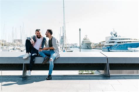 Happy Gay Couple Sitting Over Liners In Bay By Stocksy Contributor Guille Faingold Stocksy
